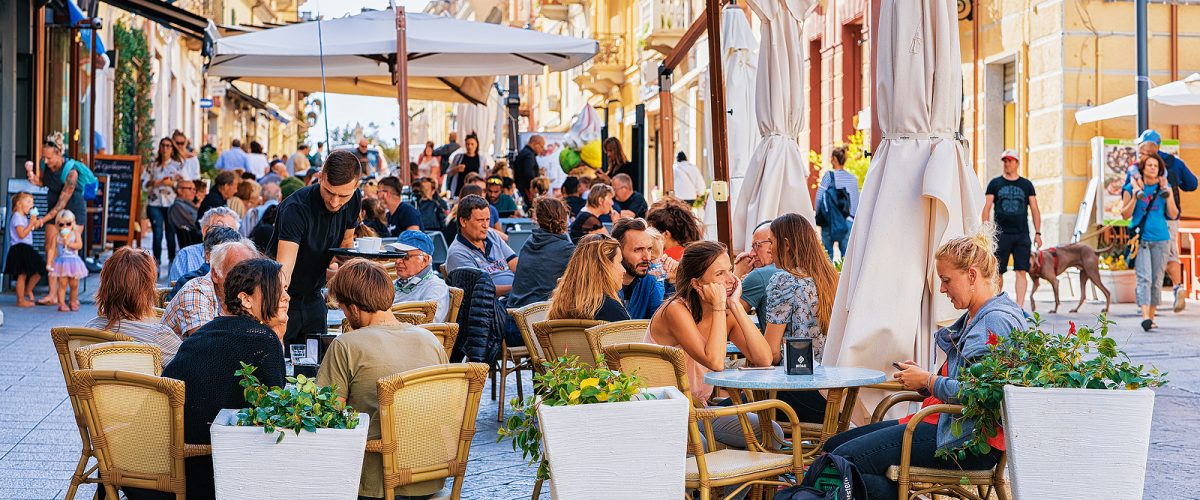 Olbia, Italy - September 11, 2017: Tourists at street cafe on Corso Umberto Street in Olbia, Sardinia, Italy